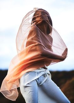 a woman in white pants and a veil on her head