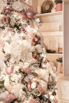 a decorated christmas tree with pink and white ornaments