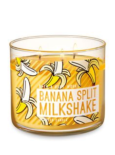 a glass jar filled with banana split and milkshake scented candle on top of a white background