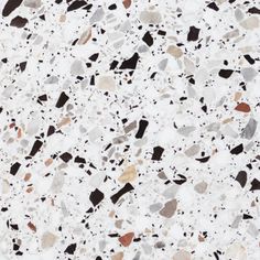 a white and brown speckled surface with black, red, gray and white dots