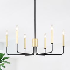 a black and gold chandelier with five candles hanging from it's center