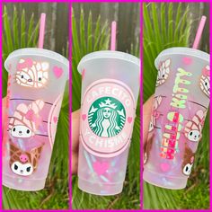 the starbucks cup is decorated with pink and green designs on its side, along with two straws