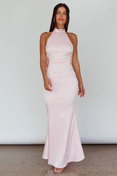 Pink Backless Evening Dress For Prom, Pink Halter Neck Formal Evening Dress, Pink Maxi Dress For Prom, Elegant Pink Satin Halter Dress, Formal Pink Halter Neck Evening Dress, Pink Backless Gown For Prom Season, Pink Backless Gown For Prom, Pink Backless Halter Dress For Formal Events, Elegant Halter Dress With Bow Tie Back For Party