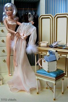 a barbie doll standing next to a dressing table