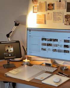 a computer monitor sitting on top of a wooden desk next to a keyboard and mouse