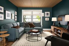 a living room filled with furniture and a flat screen tv on top of a wooden table