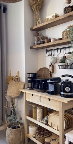 a kitchen with wooden shelves filled with pots and pans