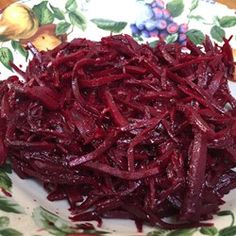 beets on a white plate with green leaves