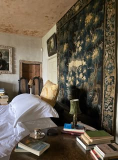 a room with a bed and many books on the table