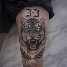 a man's leg with a tiger tattoo on it and the word ef written in black ink