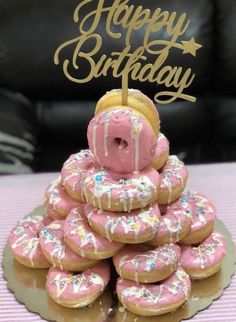 a birthday cake made out of doughnuts with sprinkles and frosting