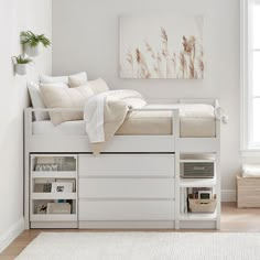 a bedroom with a bed, desk and storage drawers in the bottom bunk beds area