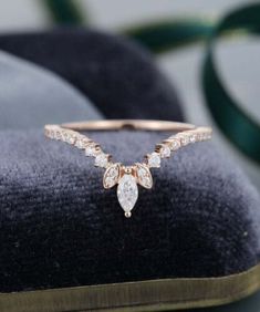 a diamond ring on top of a velvet cushion