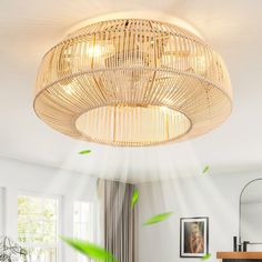 a living room filled with furniture and a bamboo chandelier hanging from the ceiling