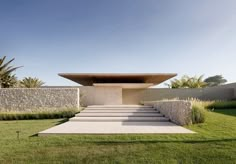 an outdoor area with steps leading up to a building that is made out of stone and grass