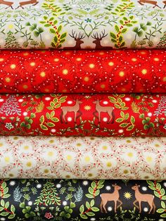 a stack of christmas fabric featuring deers and trees