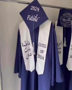 graduation caps and gowns are hanging on the wall