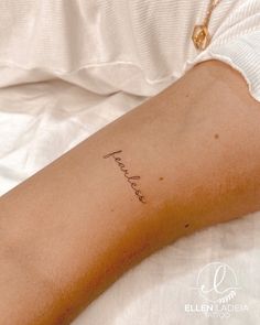 a woman's arm with a tattoo that says, peace on the left side