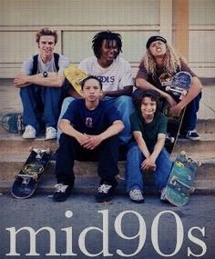 a group of young men sitting next to each other with skateboards on their feet