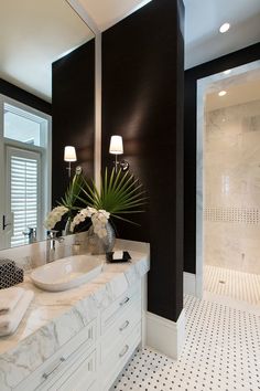 a bathroom with two sinks and a large mirror on the wall next to a walk in shower