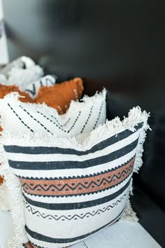 two decorative pillows sitting on top of a table