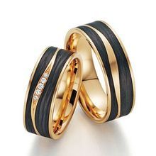 two gold wedding rings with black and white stripes on each side, set in 18k yellow gold