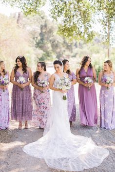 the bride and her bridesmaids are all dressed in purple dresses with floral bouquets