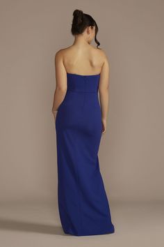 a woman in a blue dress looking back