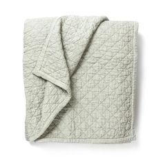 the white quilted blanket is folded up