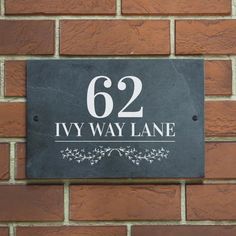 a brick wall with a sign on it that says,'52 ivy lane '