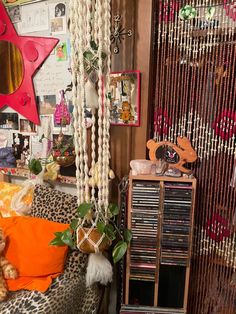 a room filled with lots of different items and decor on the walls, including a leopard print chair