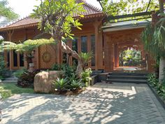 a house that is surrounded by trees and plants