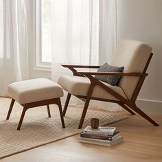 a chair and ottoman in front of a window