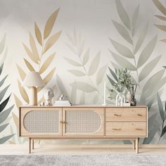 a living room scene with focus on the sideboard and wallpaper that has leaves painted on it