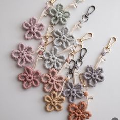 the keychains are all different colors and have flowers attached to each one's lanyard