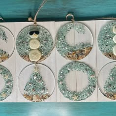 six glass ornaments with buttons and snowmen on them