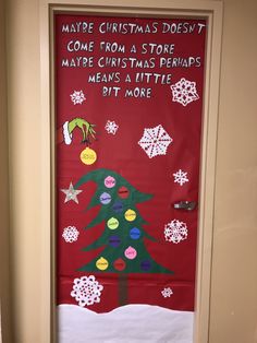 a christmas door decorated with paper snowflakes and a tree on the front, says maybe christmas doesn't come from a store maybe christmas perhaps means a little bit more