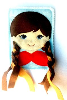 the doll is wearing a red shirt and brown hair with braids on it's head