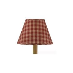 a lamp with a red plaid shade on it