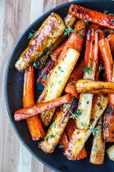 roasted carrots with herbs in a black bowl