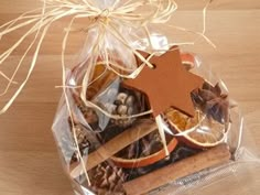 a bag filled with cookies, nuts and a wooden star on top of a table