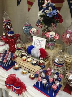 patriotic dessert table with cupcakes, cake pops and candies on wooden crates