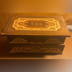 an ornate wooden box sitting on top of a table