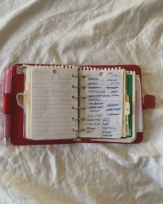 an open notebook sitting on top of a bed