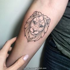 a woman's arm with a small tattoo of a lion on the left forearm