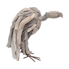 a bird made out of driftwood on a white background