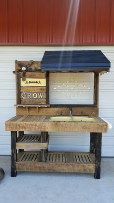 a wooden bench sitting in front of a garage door with a solar panel on top