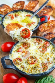 a person holding up a piece of pizza with cheese and tomatoes on it in front of other baked goods