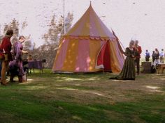 two people standing in front of a tent