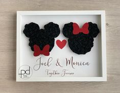 two mickey and minnie mouse magnets in a white shadow box with red heart accents